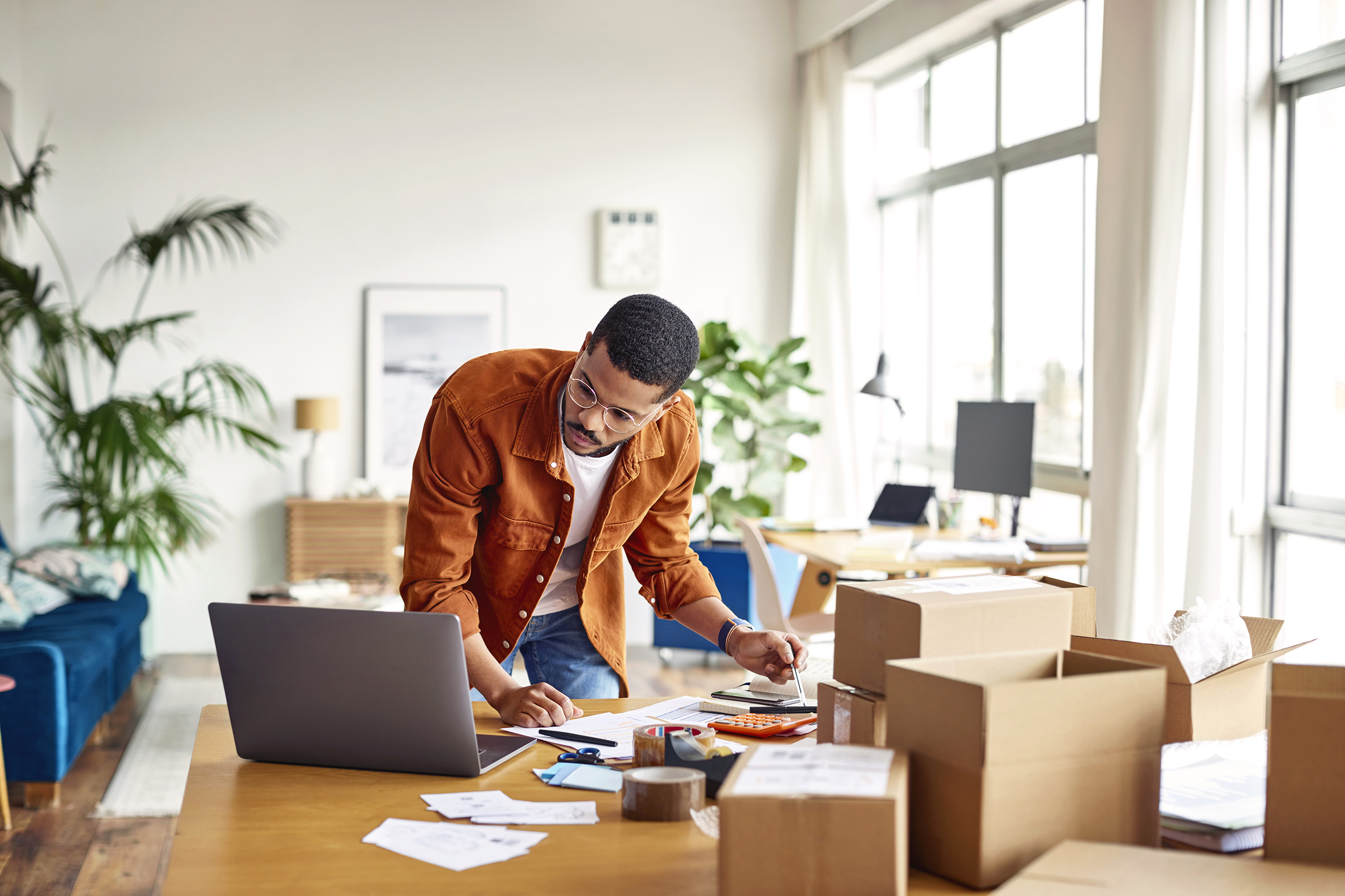 Businessman Analyzing Documents In Home Office
